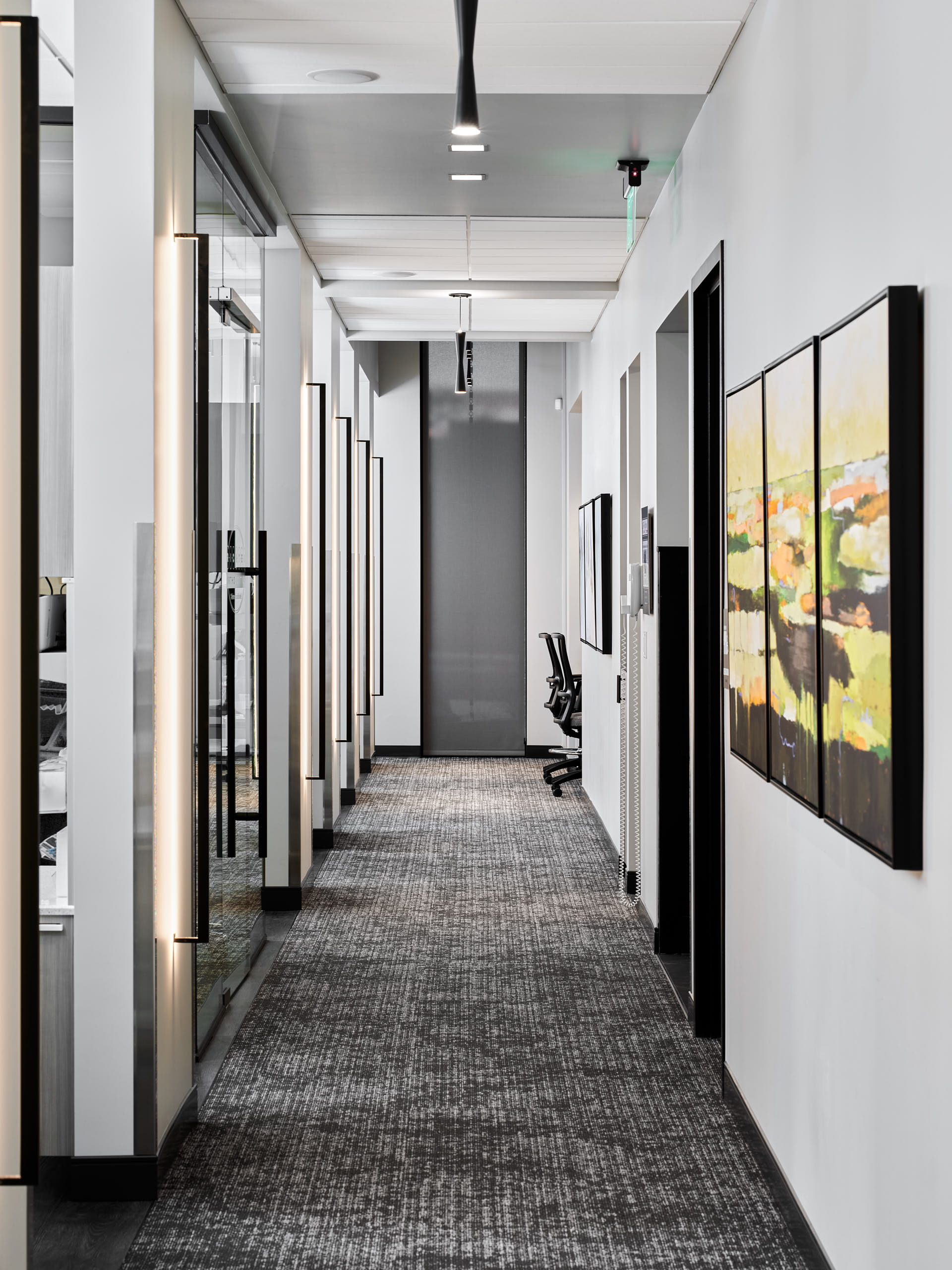 Commercial interior photography by Warren Diggles. 1 point perspective of Richter Orthodontics treatment rooms hallway. Project by Design Ergonomics, VFLA Architects, and Elder Construction.